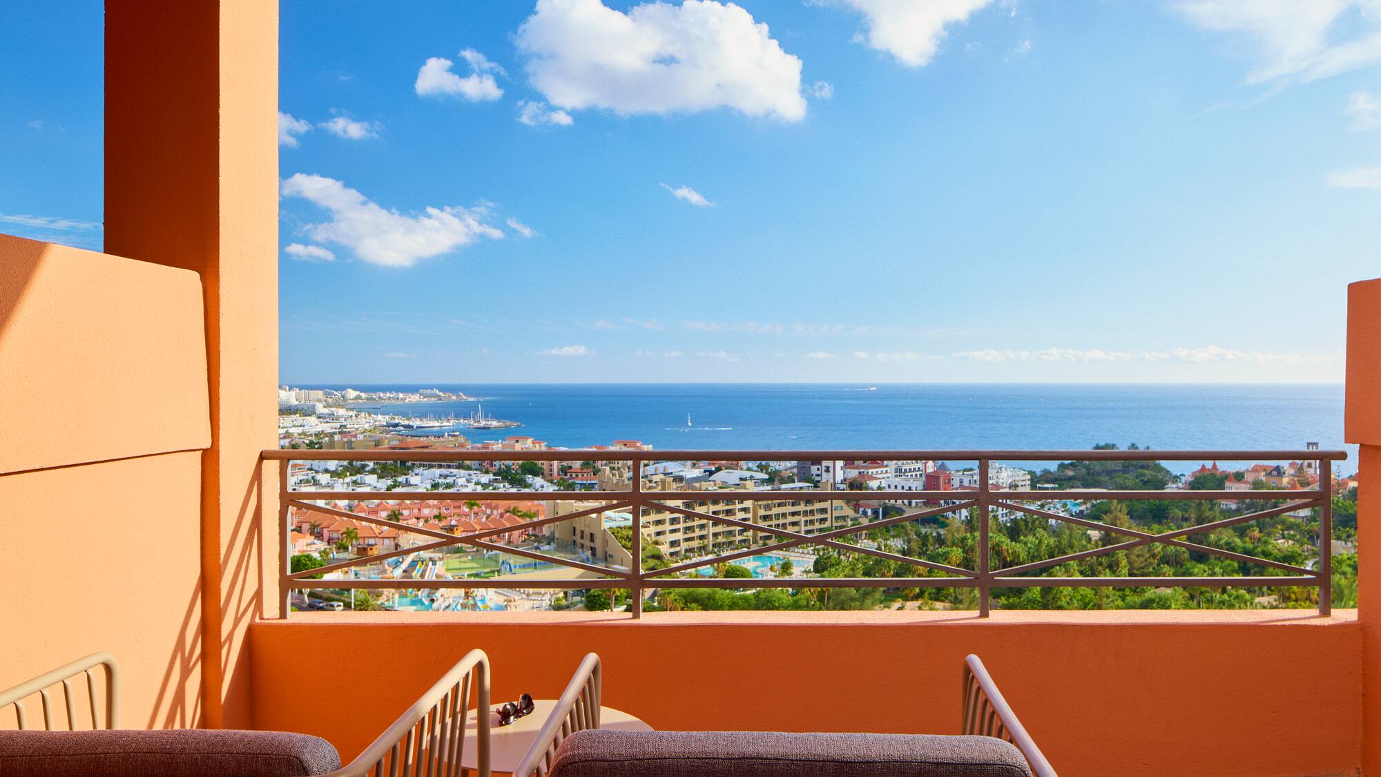 a balcony with a view of the ocean and a city