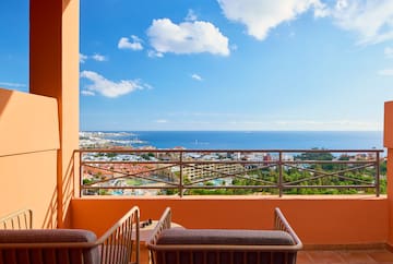 a balcony with a view of the ocean and a city