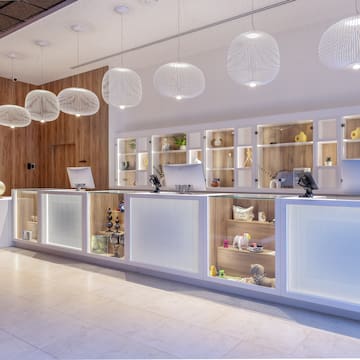 a reception desk with shelves and lights