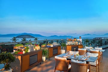 a restaurant with a view of the ocean and mountains