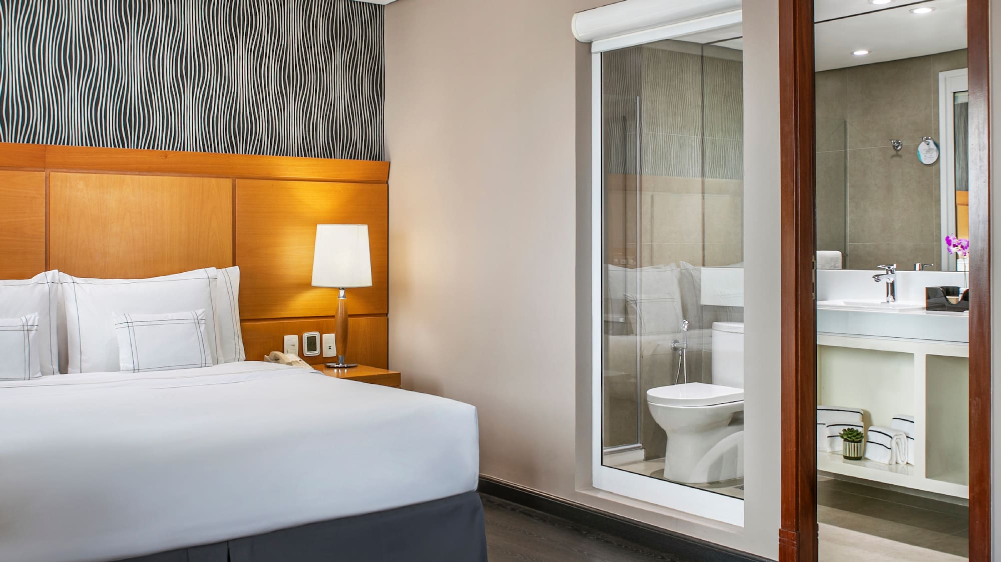 a bedroom with a bed and a mirror