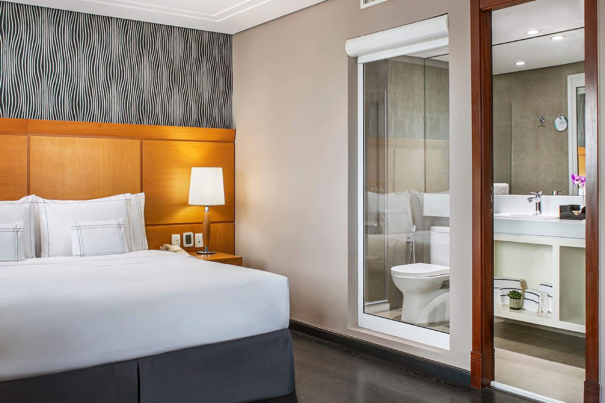 a bedroom with a bed and a mirror