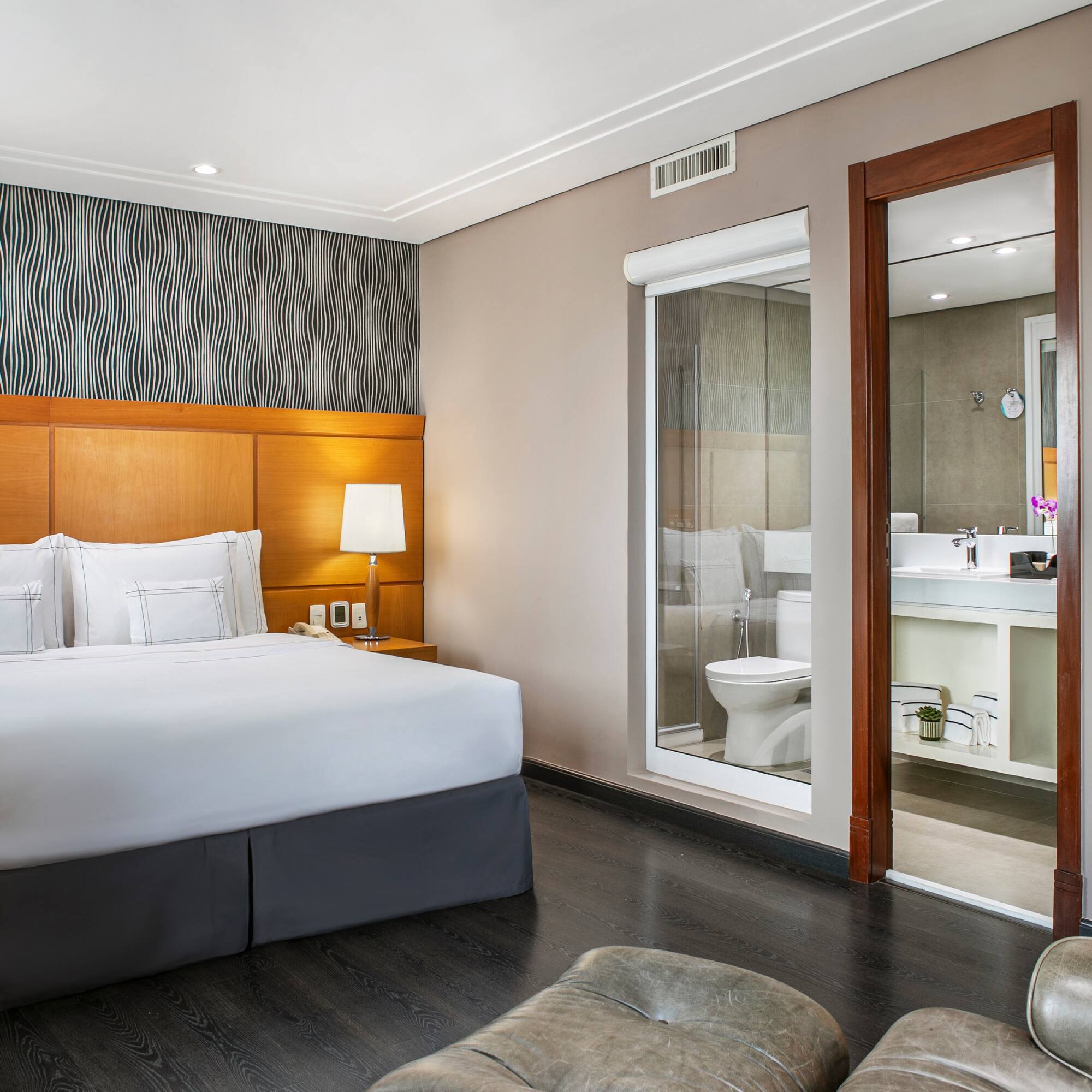 a bedroom with a bed and a mirror