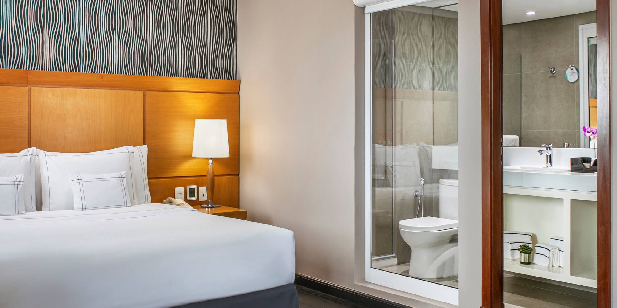 a bedroom with a bed and a mirror