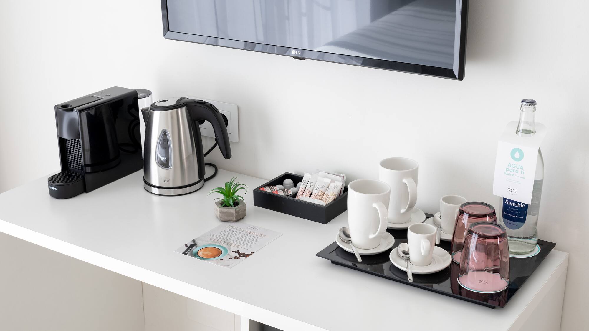 a coffee pot and cups on a table