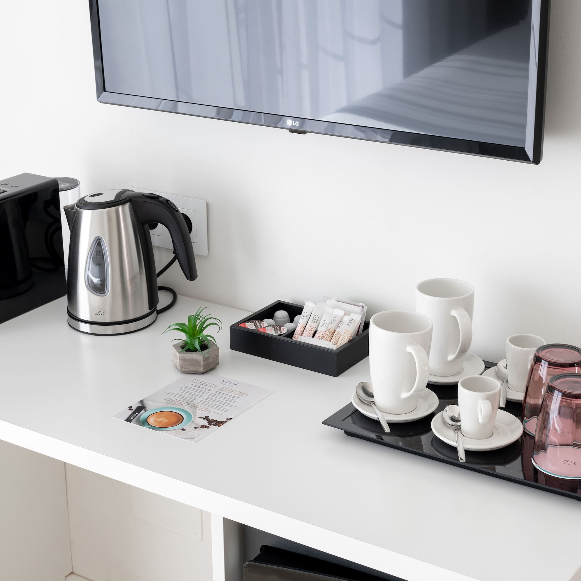 a coffee pot and cups on a table