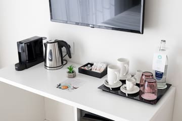 a coffee pot and cups on a table