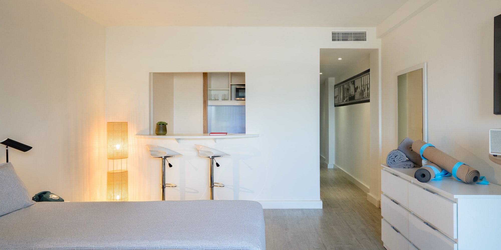 a room with a bed and a dresser