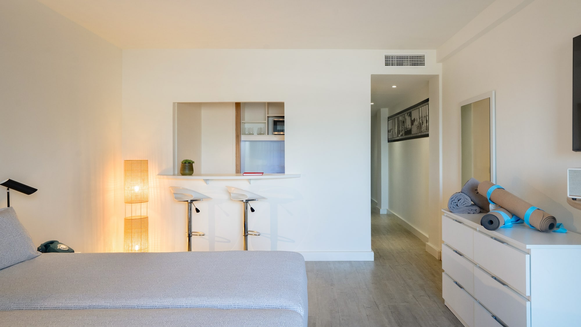 a room with a bed and a dresser