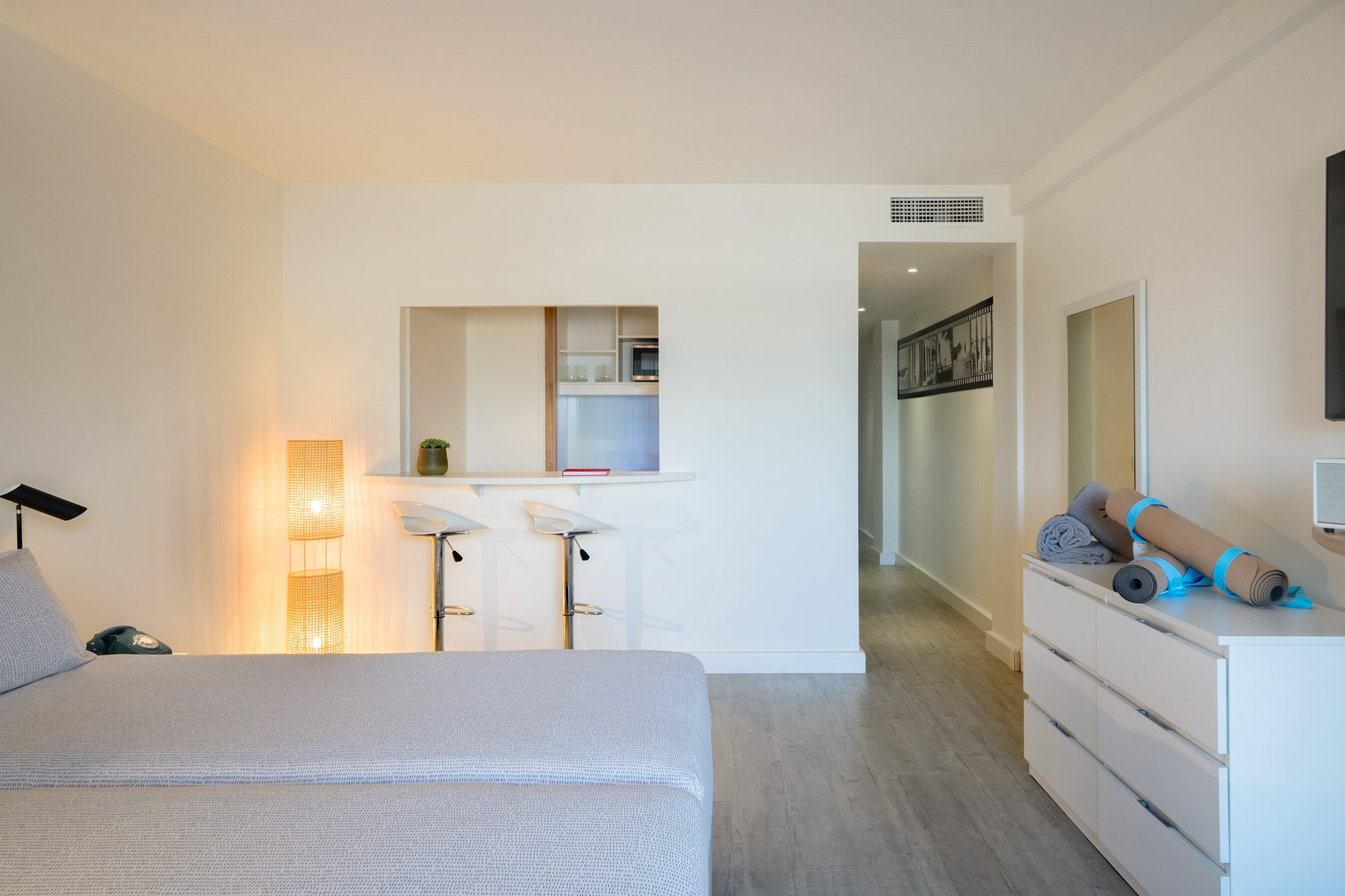 a room with a bed and a dresser