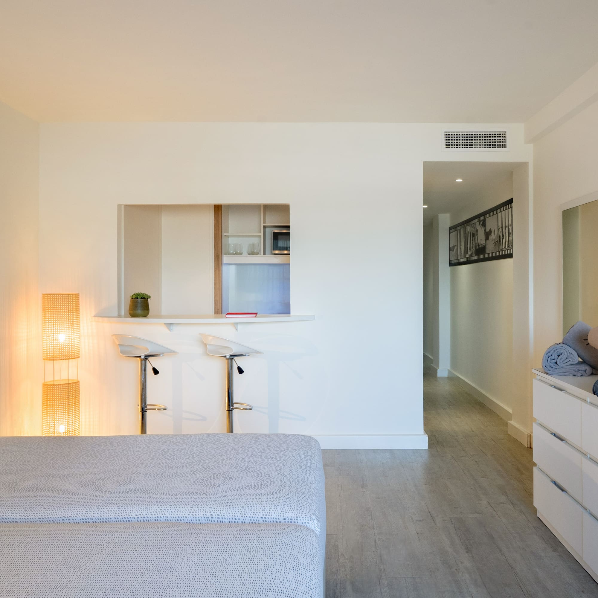 a room with a bed and a dresser