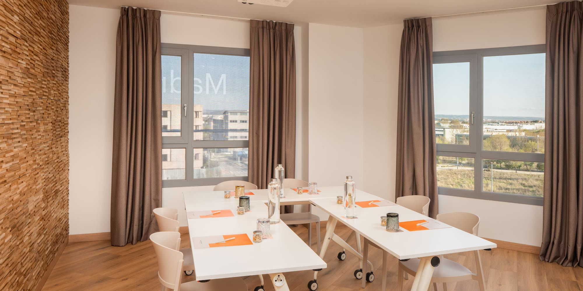 a room with white tables and chairs