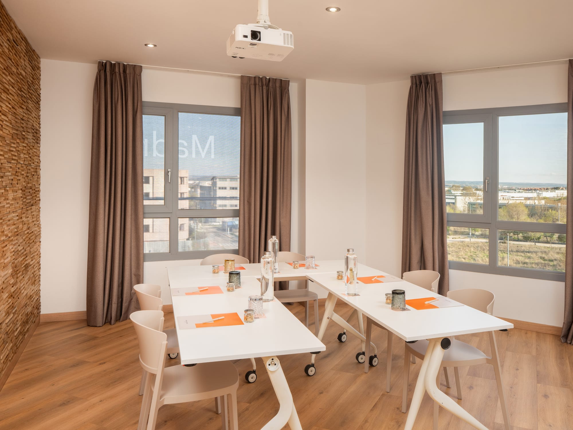 a room with white tables and chairs