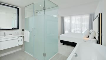 a bathroom with a glass shower and a bathtub