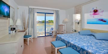 a room with a bed and chairs and a table