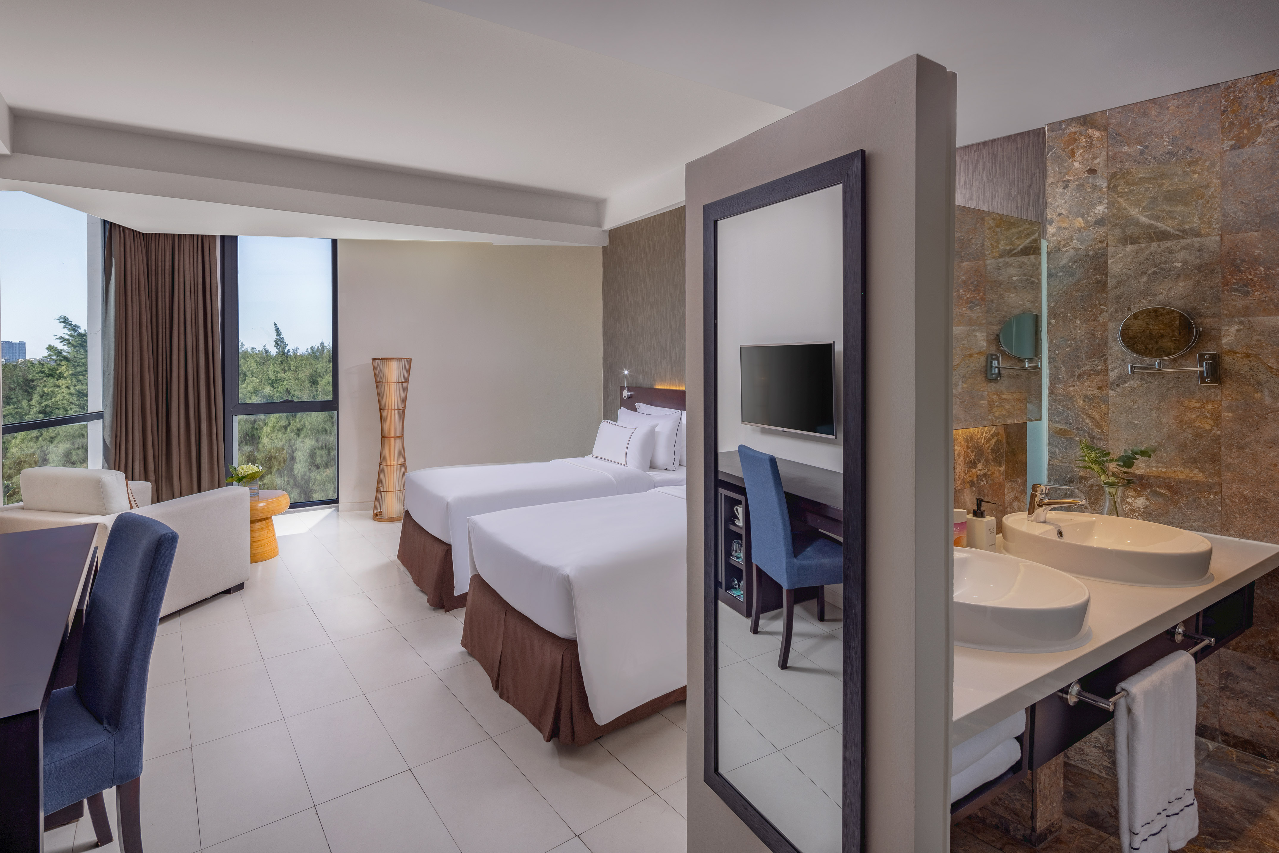 a room with two beds and a sink