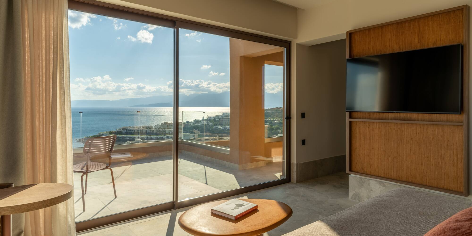 a living room with a glass sliding door and a table