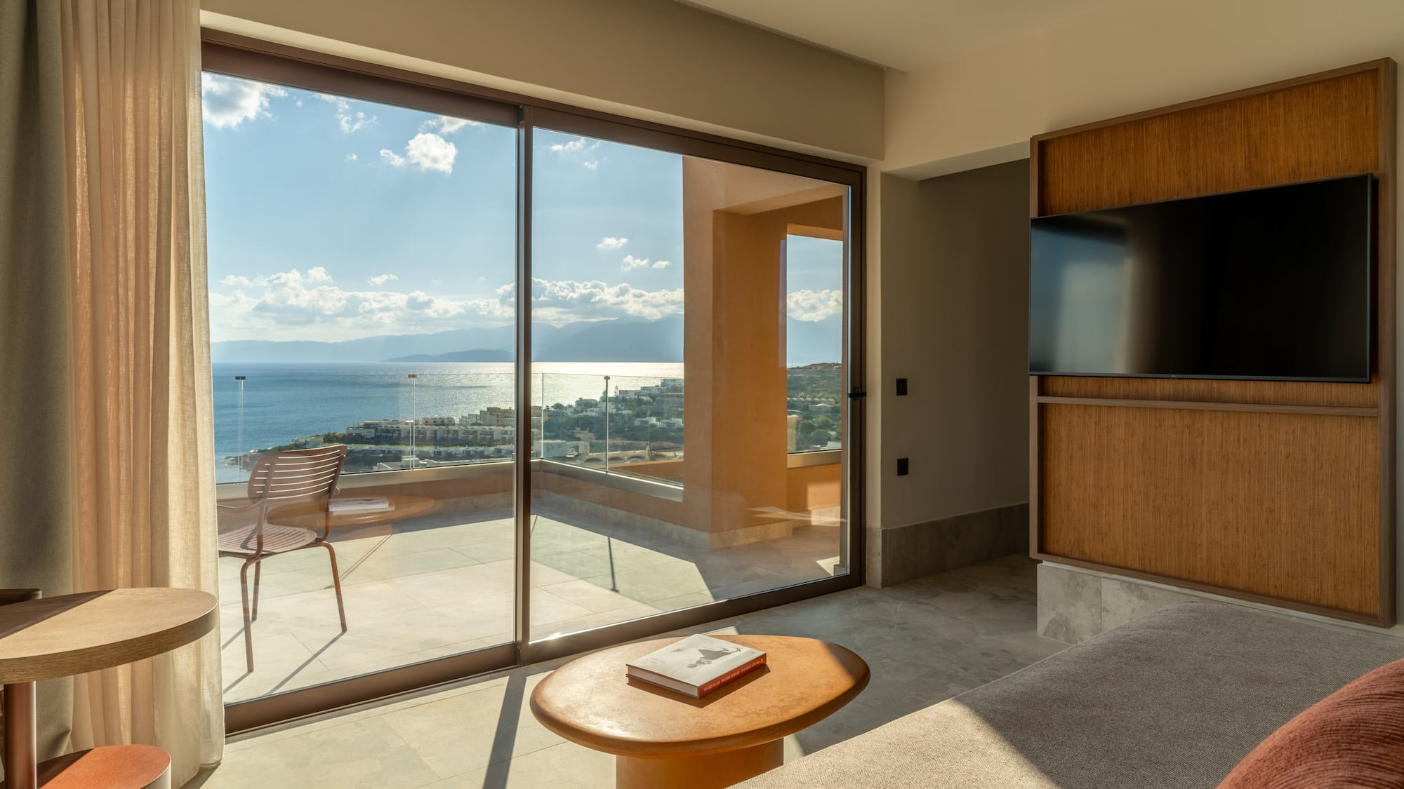 a living room with a glass sliding door and a table