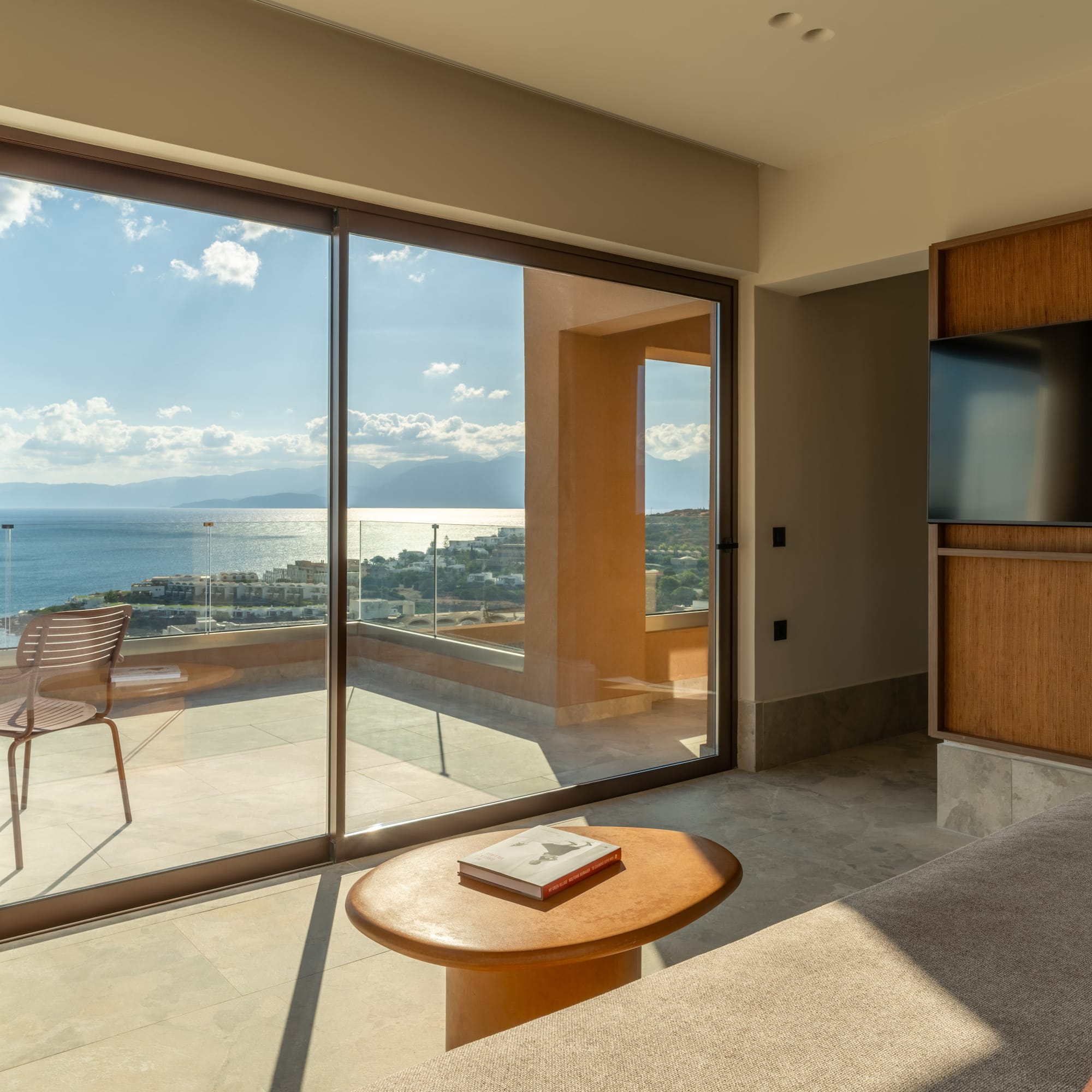 a living room with a glass sliding door and a table