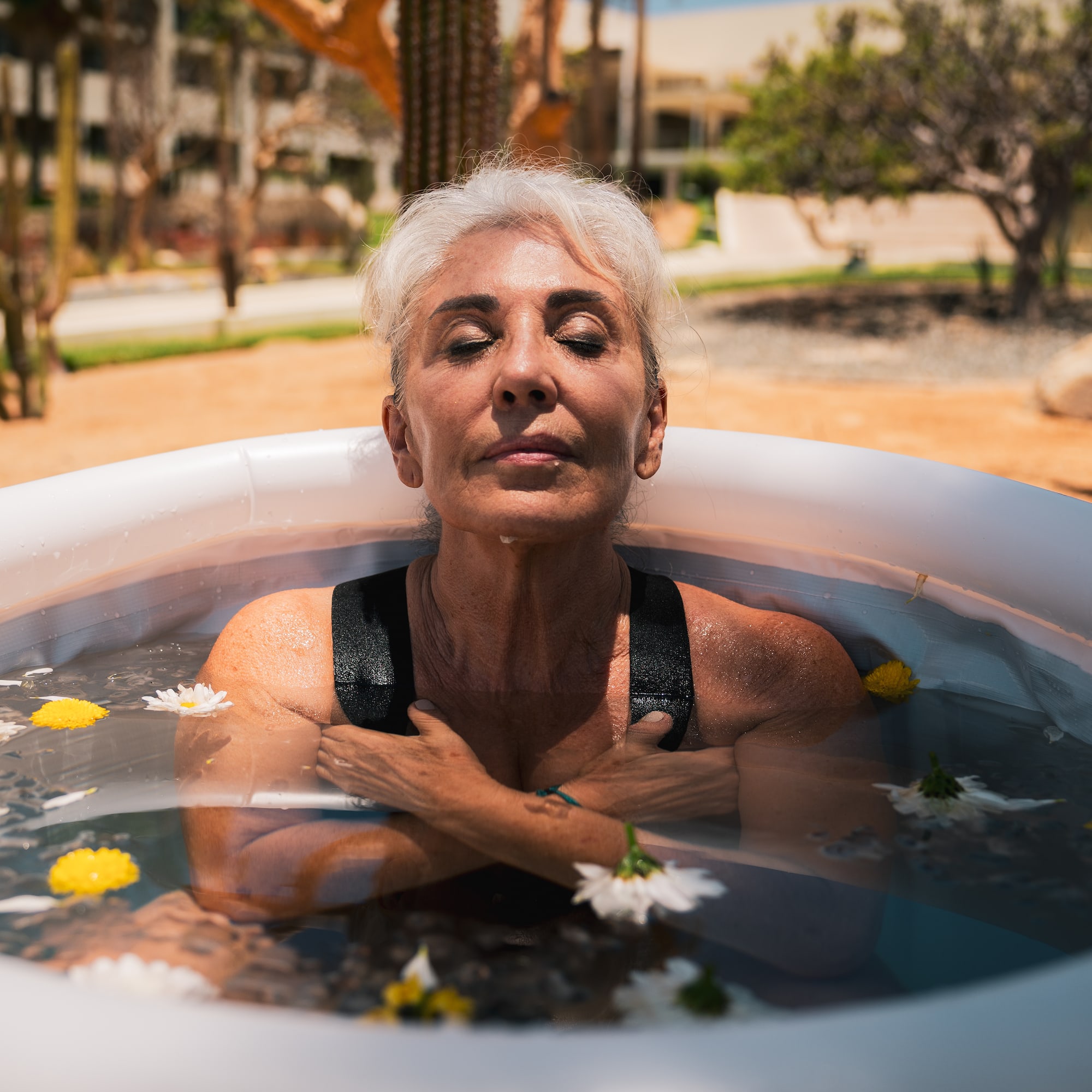 a woman in a pool of water with flowers
