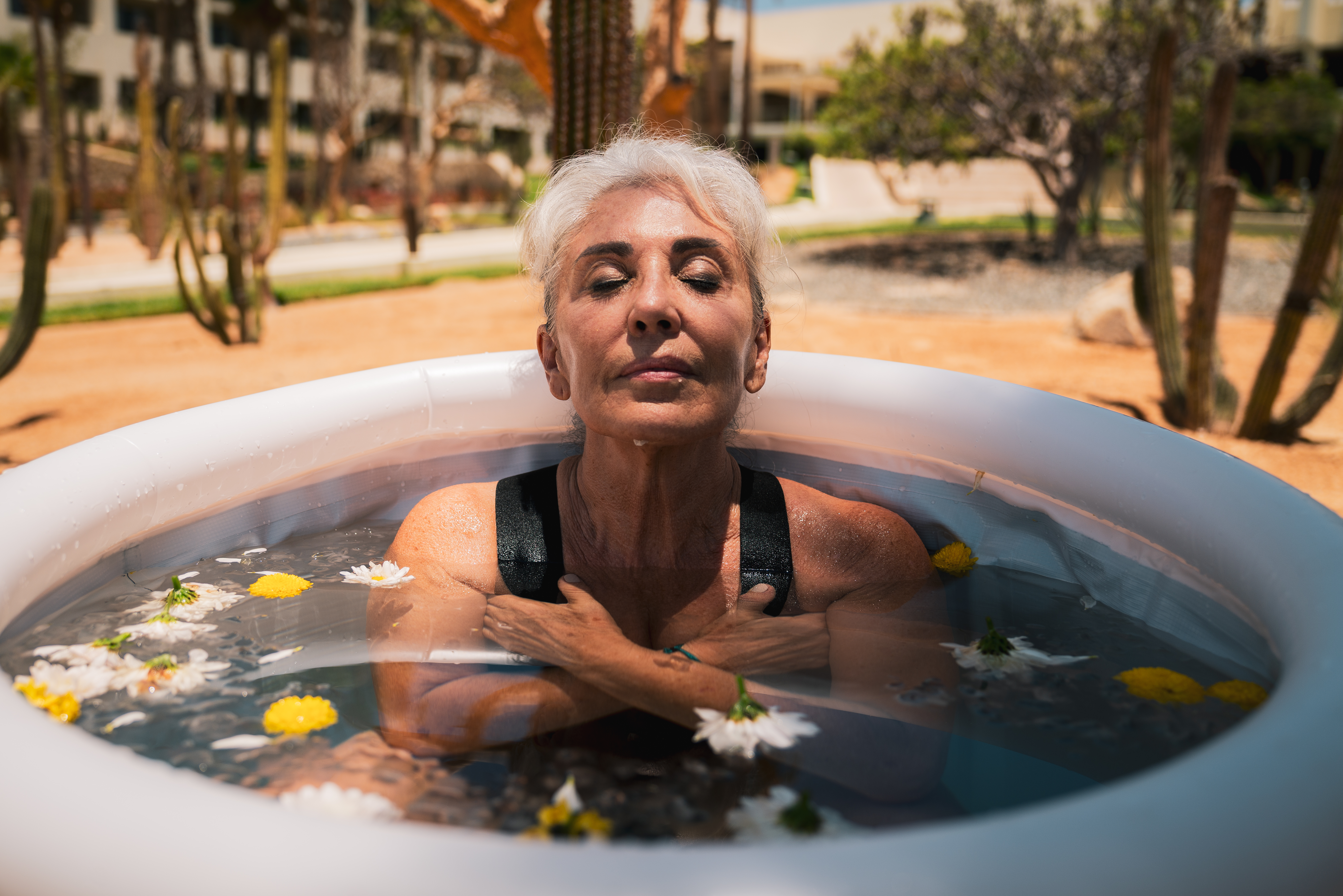 a woman in a pool of water with flowers