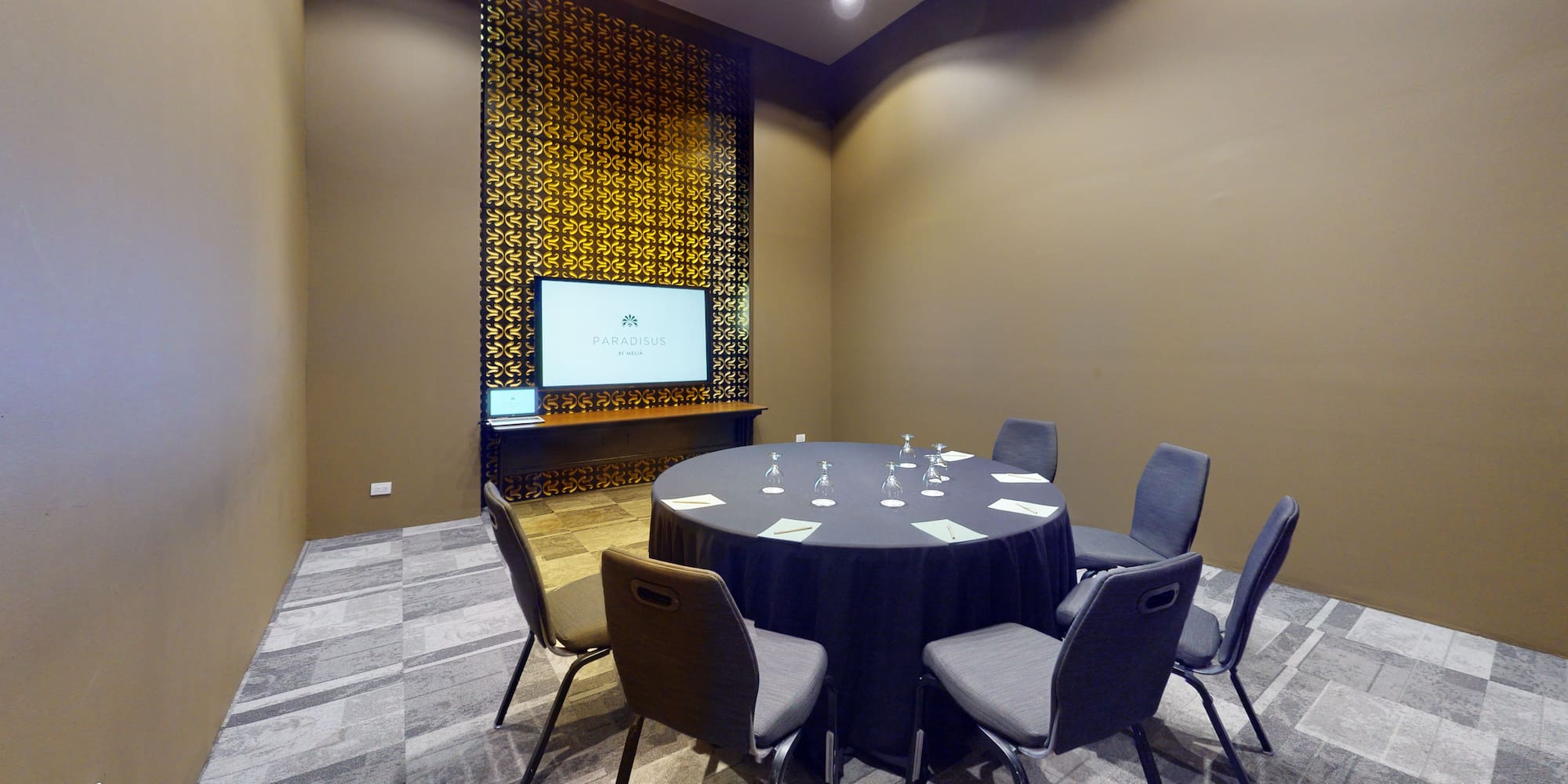 a room with a round table and chairs