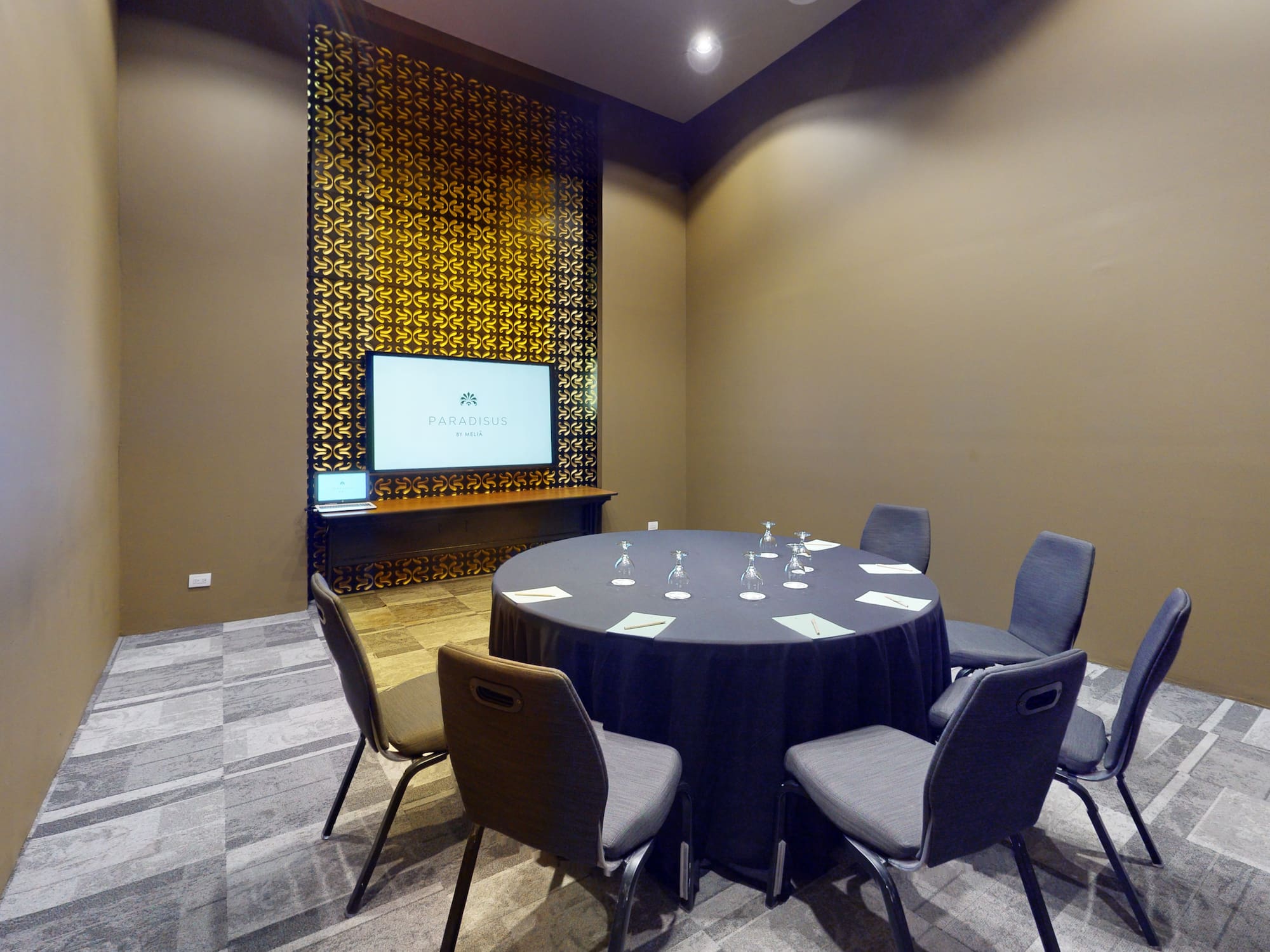 a room with a round table and chairs
