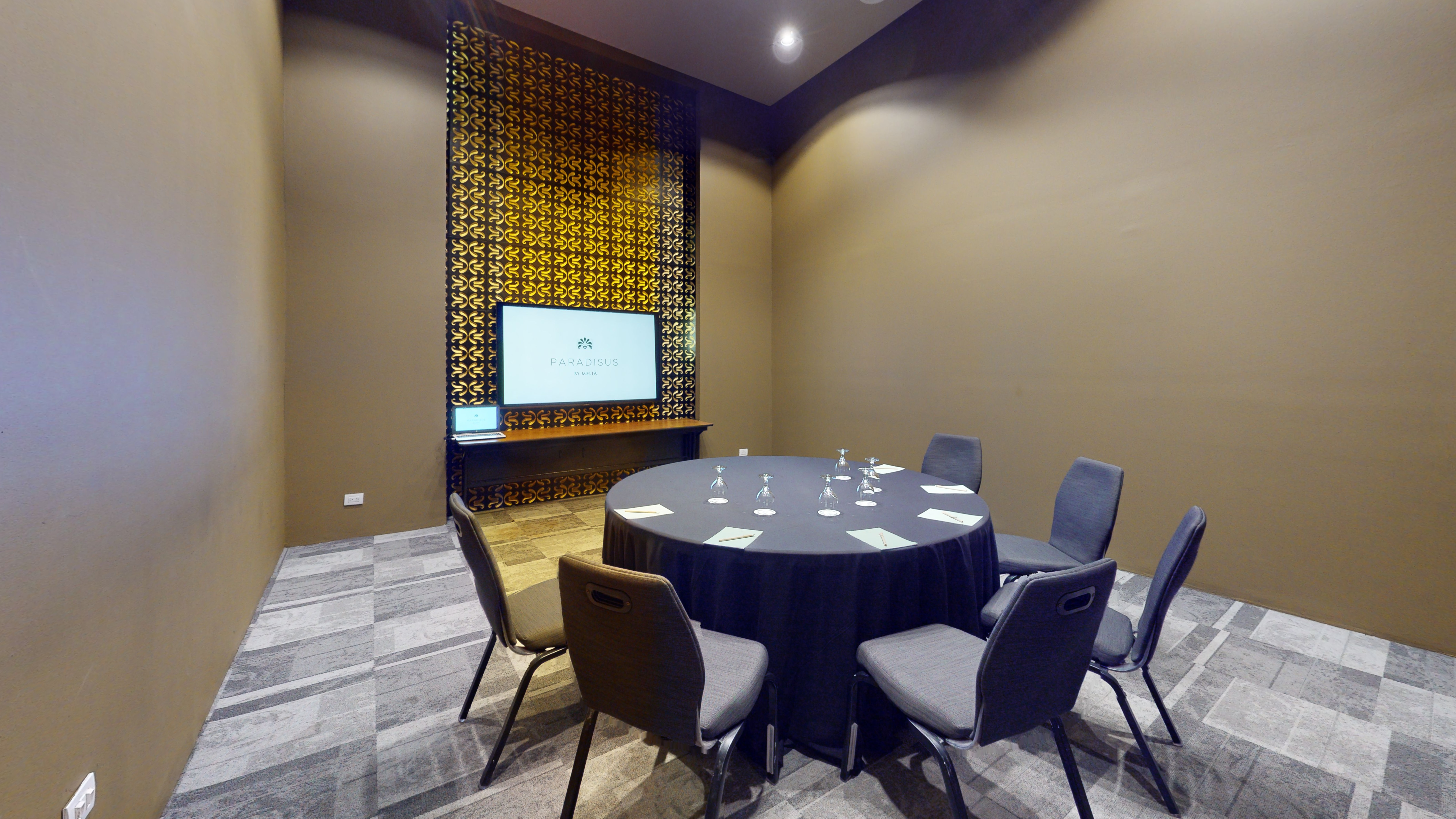 a room with a round table and chairs