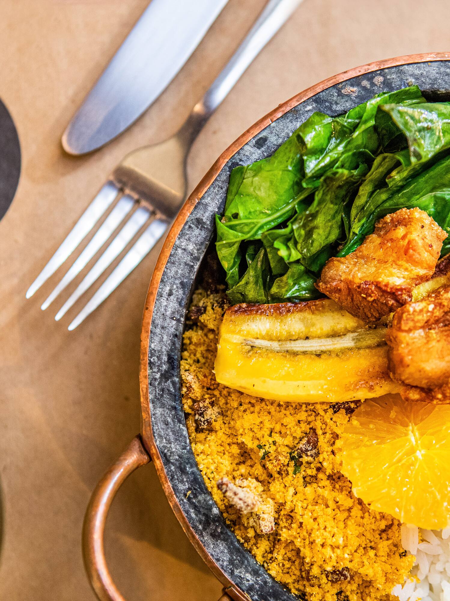 a bowl of food with a fork and knife