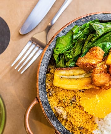 a bowl of food with a fork and knife