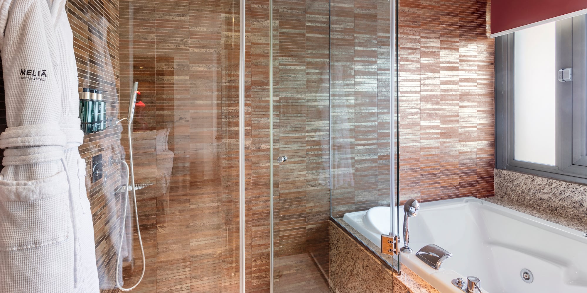 a bathroom with a glass shower and tub