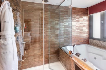 a bathroom with a glass shower and tub