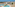 Coastal resort: large pools, kids' water park with slides, and hotel buildings.