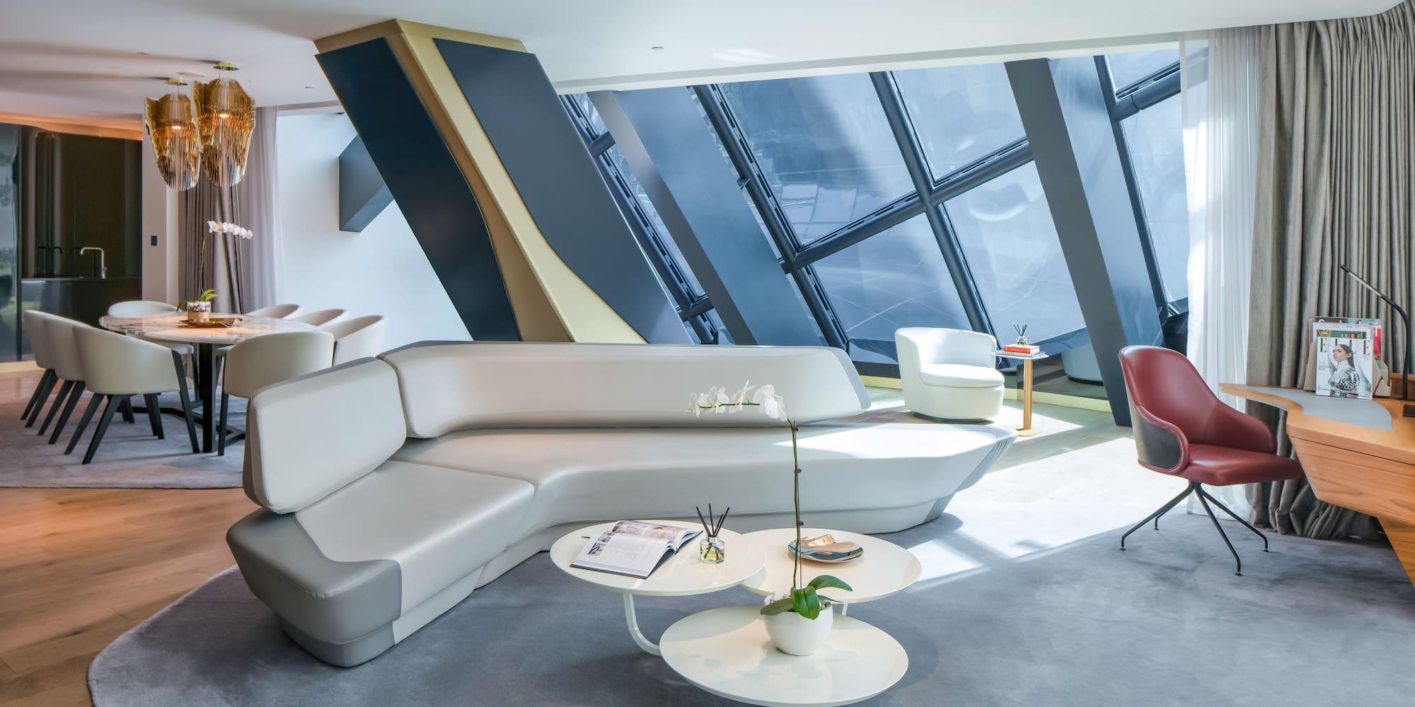 a room with a couch and chairs