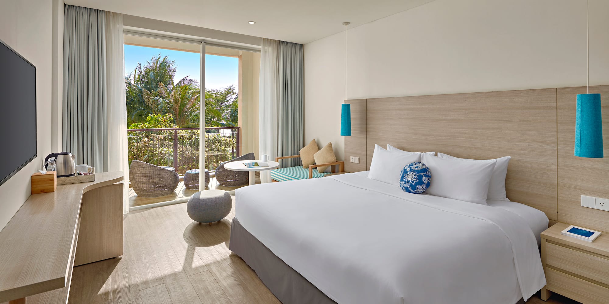 a bedroom with a large bed and a glass door