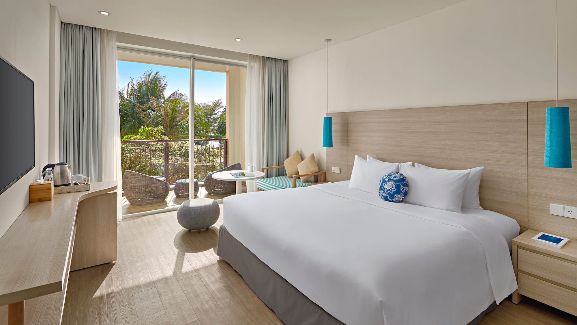 a bedroom with a large bed and a glass door