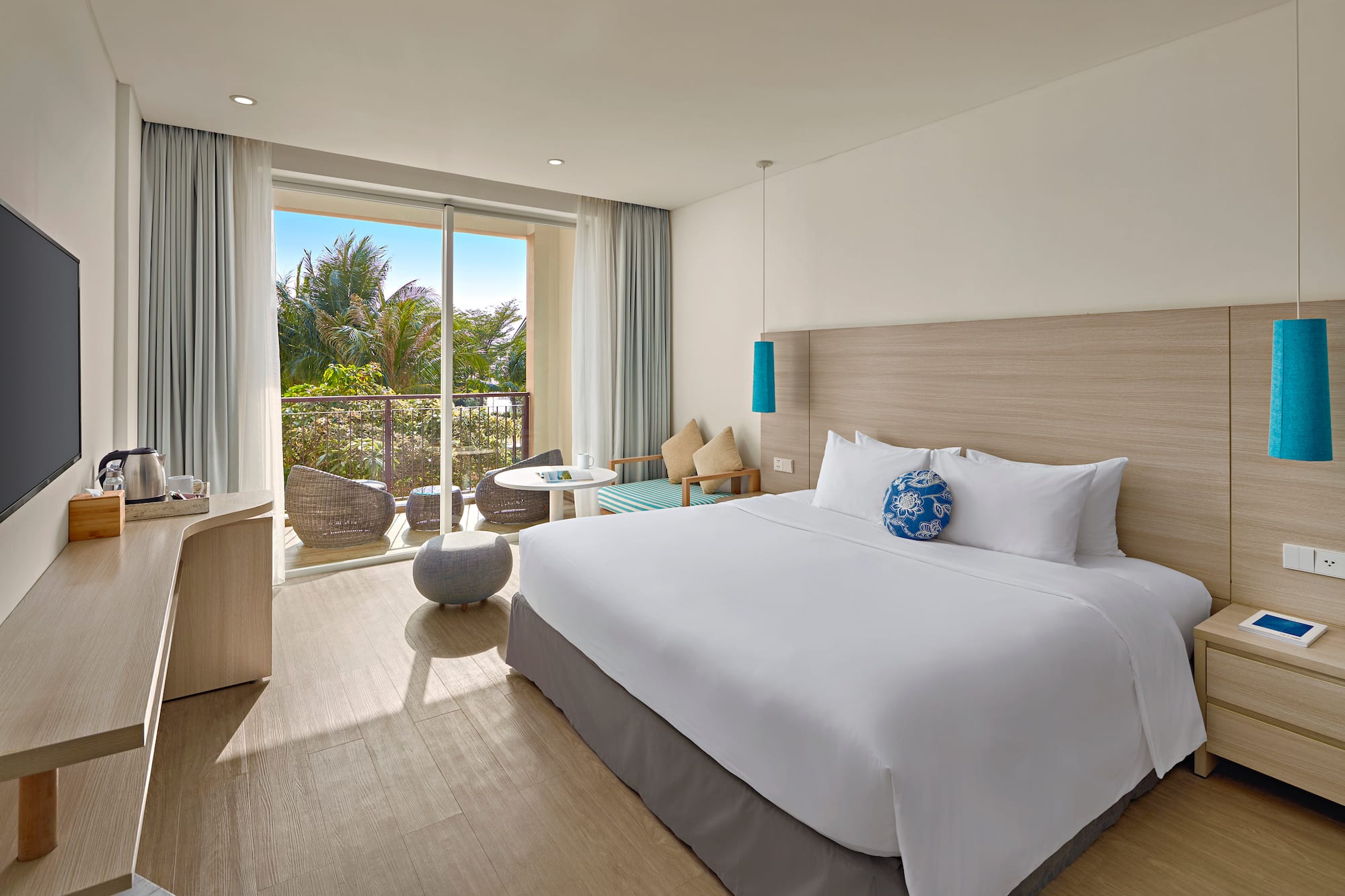 a bedroom with a large bed and a glass door