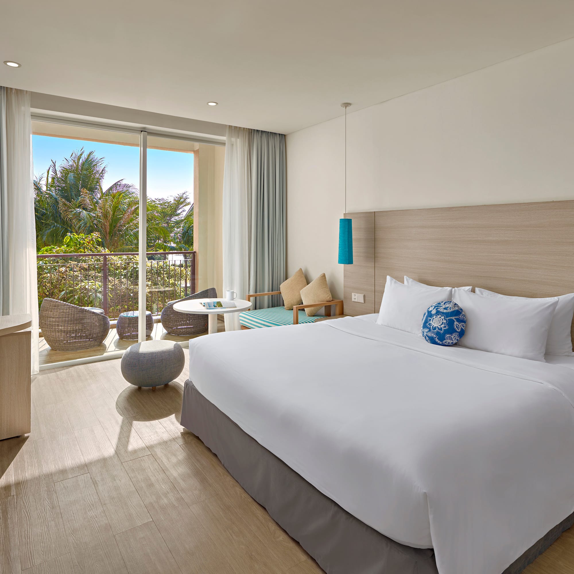 a bedroom with a large bed and a glass door