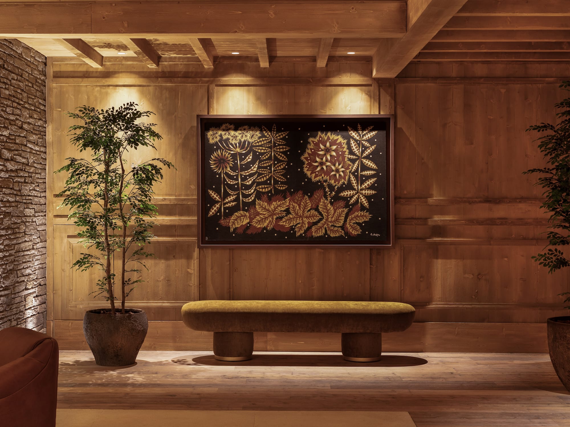 a room with a bench and a plant in a pot