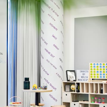 a room with a white board and shelves