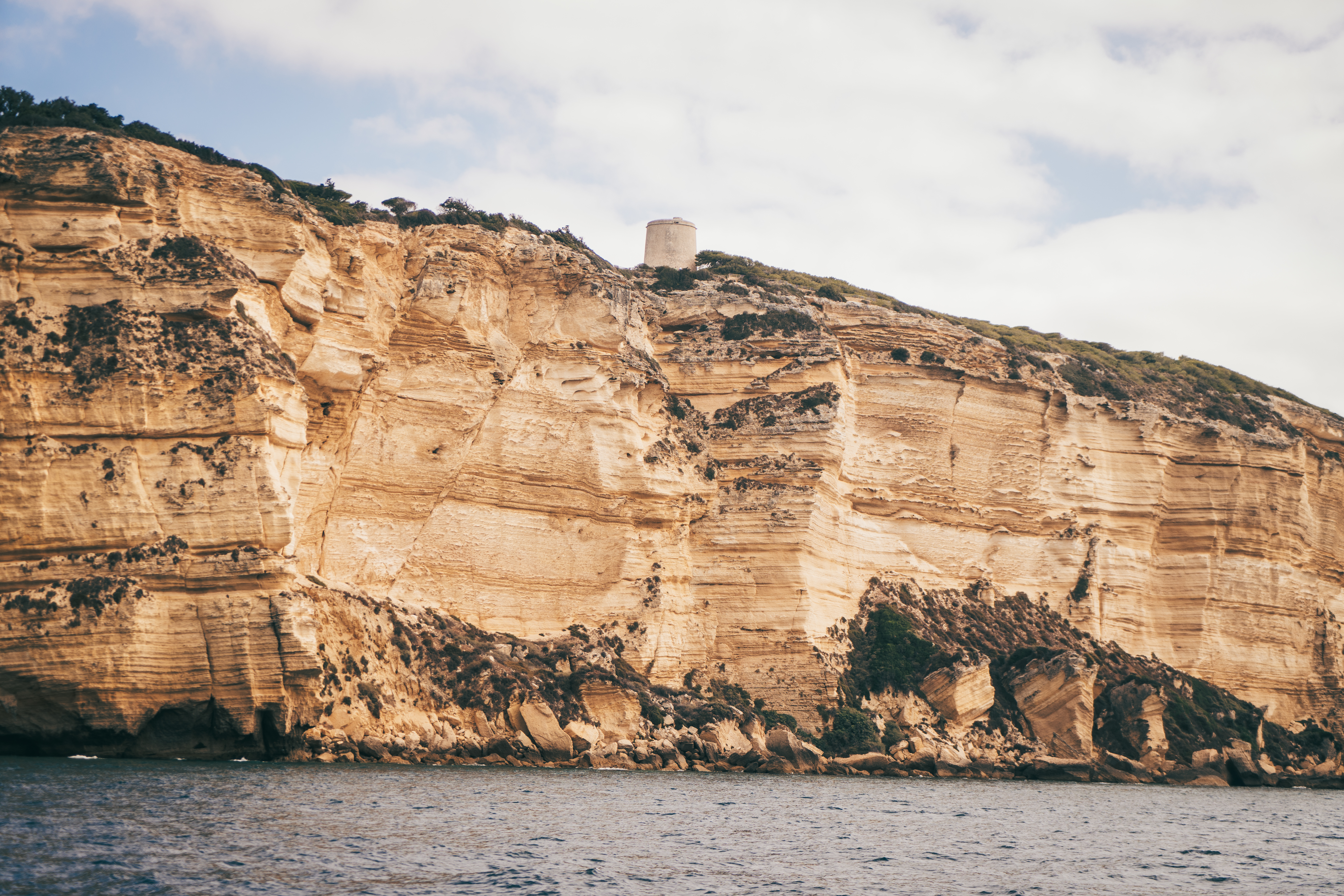 a large cliff with a tower on top of it