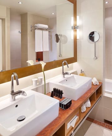 a bathroom with two sinks and a mirror
