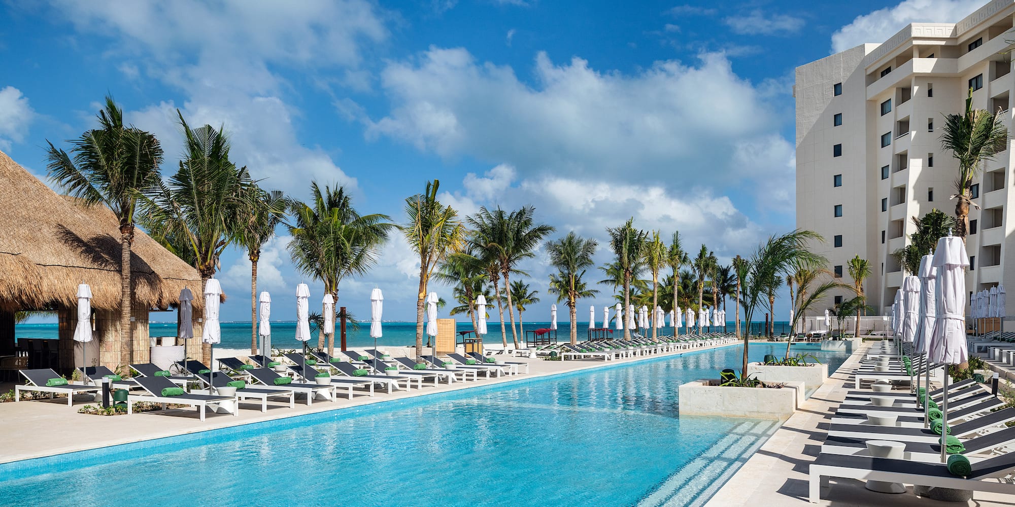 a pool with lounge chairs and palm trees