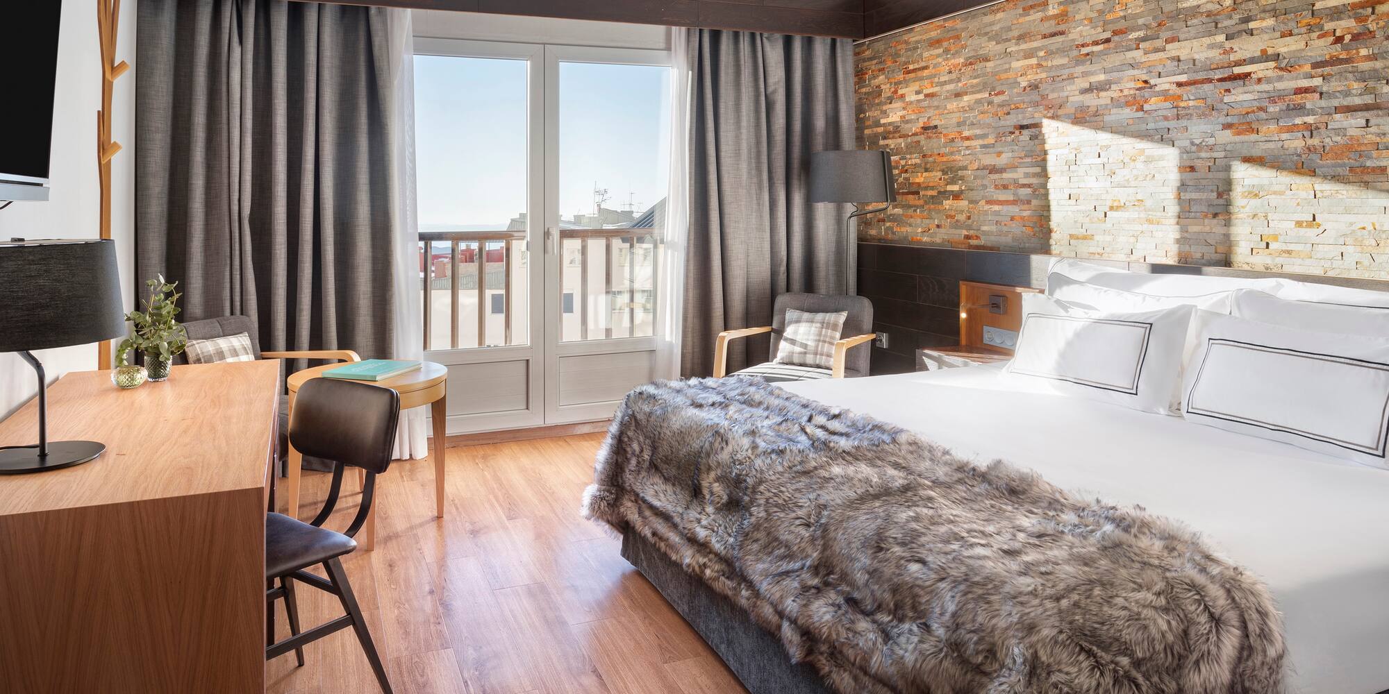 a room with a bed and a table and chairs