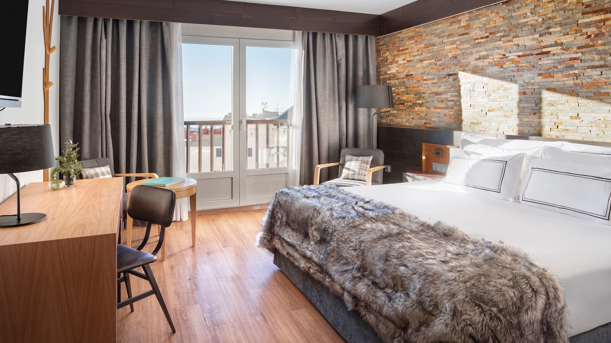 a room with a bed and a table and chairs