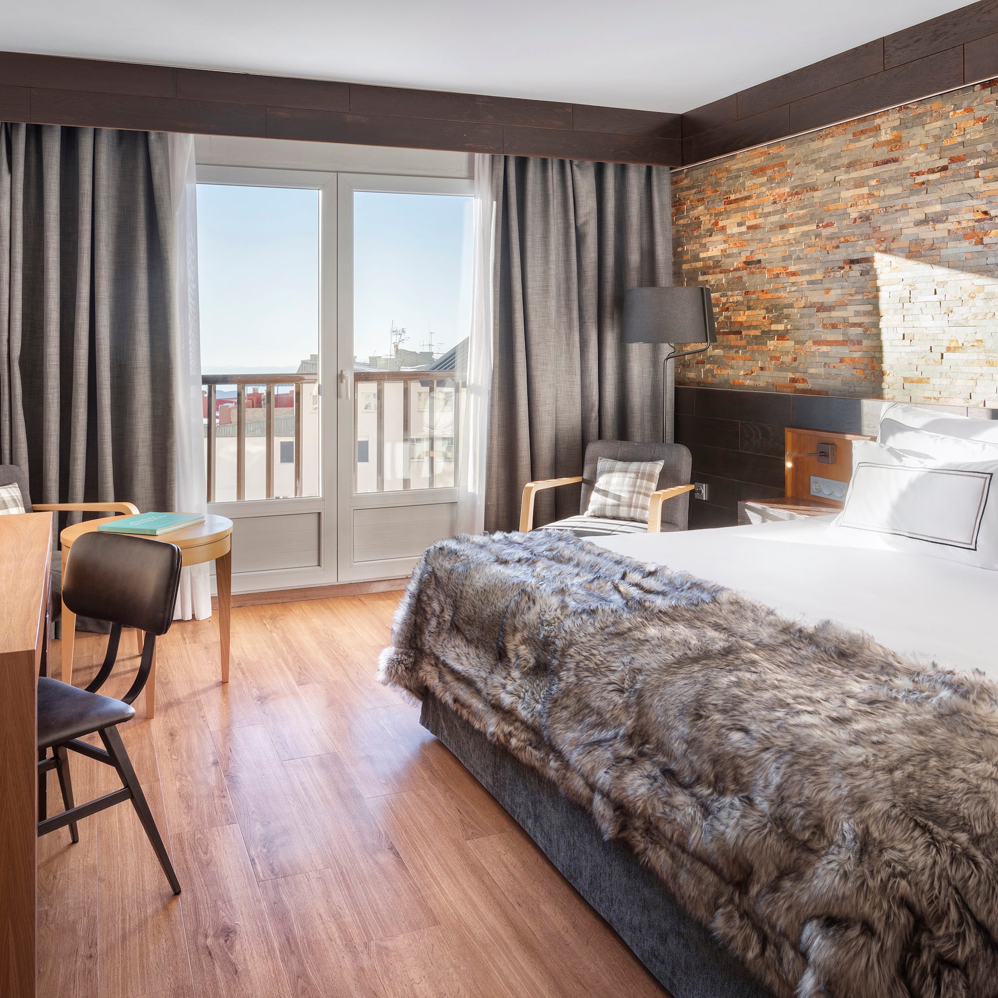 a room with a bed and a table and chairs