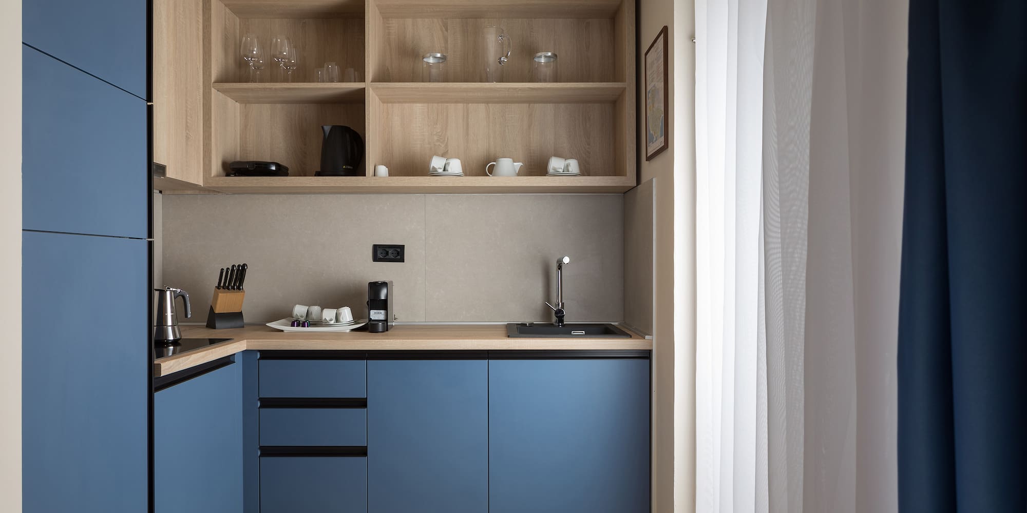 a kitchen with blue cabinets and shelves