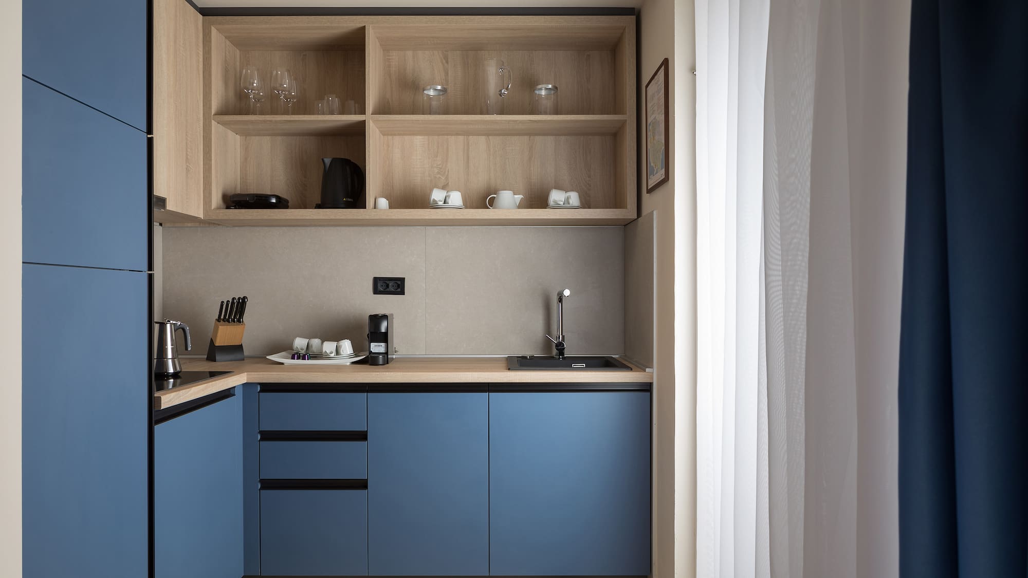a kitchen with blue cabinets and shelves