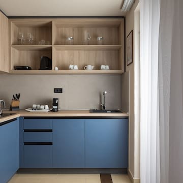 a kitchen with blue cabinets and shelves