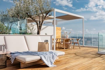 a deck with a chair and table and chairs and a tree